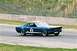 1965 Ford Mustang - A blue 1965 Ford Mustang race car speeds around a track, displaying the number 2 on its side.
