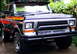 1979 Ford Bronco - This Ford Bronco features a distinctive stripe graphic along its side and a protective bull bar on the front.