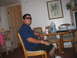 1980 Ford Bronco - A man sits at a table in a room, with a large water jug and a cup visible on the table.