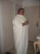 1980 Ford Bronco - Man dressed in a toga and crown holds a drink in a room with closed doors.