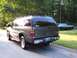 2002 Chevrolet Suburban - This 2002 Chevrolet Suburban is seen from the rear, parked on a road with another car in the background.