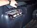 2002 Chevrolet Suburban - The interior console of a vehicle shows exposed wiring and electronic components within an open compartment.