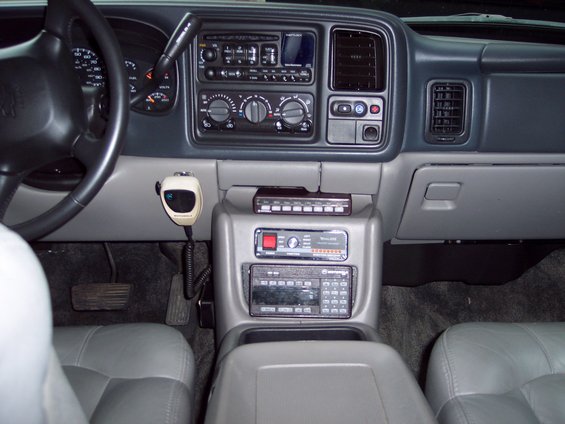 Interior of a 2002 Chevrolet Suburban showing dashboard, steering wheel, and center console with radio and CB