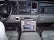 2002 Chevrolet Suburban - The interior of a 2002 Chevrolet Suburban features a dashboard with a CB radio and multiple other electronic devices mounted on the center…