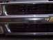 2002 Chevrolet Suburban - Close-up view of a vehicle's front grille and bumper, showing chrome accents and black grates.