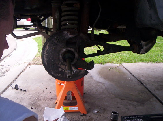 Once you remove the spindle, you can pull the shield right off, after lifing up the axle. 