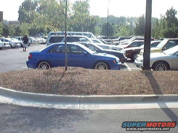 Blue Subaru Impreza WRX parked in a lot with other cars