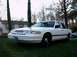 1996 Ford Crown Victoria - A white 1995 Ford Crown Victoria is parked on a grassy lawn in front of a house.