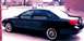 2000 Ford Taurus - Side profile of a black 2000 Ford Taurus sedan with aftermarket wheels.