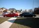 2000 Ford Taurus - A black 2000 Ford Taurus sedan is parked on the street next to a red coupe.