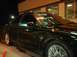 2000 Ford Taurus - A black sedan is parked outside a building at night, with writing on its windshield.