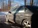 2000 Ford Taurus - A dirty, frost-covered 2000 Ford Taurus sedan is seen from the side on a winter day.