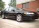 2000 Ford Taurus - This black sedan, likely a 1992 model, is parked in front of a brick building.