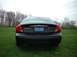 2000 Ford Taurus - Rear view of a black 2000 Ford Taurus SE sedan parked in a grassy field.