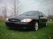 2000 Ford Taurus - Front 3/4 view of a black 2000 Ford Taurus sedan on a grassy area.