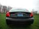 2000 Ford Taurus - Black 2000 Ford Taurus SE parked on grass with trees in the background.