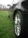 2000 Ford Taurus - Side view of a black sedan with a chrome wheel parked in a grassy field.