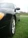 2000 Ford Taurus - A black 2000 Ford Taurus is shown from the side, shiny chrome wheels and a clean exterior.