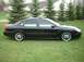 2000 Ford Taurus - Side view of a black 2000 Ford Taurus sedan on a sunny day.