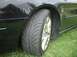 2000 Ford Taurus - A close-up view of a vehicle's side, focusing on the fender and tire with a chrome wheel.