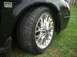2000 Ford Taurus - A close-up view of a car's fender and a chrome wheel with a tire.