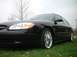 2000 Ford Taurus - Front quarter view of a black 2000 Ford Taurus with custom chrome wheels.