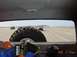 1996 Ford Bronco - Several vehicles are driving on a wide, sandy beach with the ocean in the background.