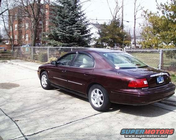 Maroon sedan, rear 3/4 view. License plate reads NLF 513