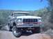 1979 Ford Bronco - This 1979 Ford Bronco is seen from the front, with a man behind the wheel, on a dirt road.