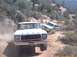 1979 Ford Bronco - A 1979 Ford Bronco leads a silver pickup truck up a steep, dusty desert incline.