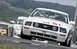 2005 Ford Mustang - White 2005 Ford Mustang race car with 'FORD RACING' banner and number 51 competes on a track.