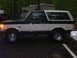1991 Ford Bronco - This 1991 Ford Bronco is shown in a side profile, with a dark green top and trim contrasting with its white body.