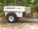 1991 Ford Bronco - A white Trailblazer Camper trailer is parked outdoors, a diamond plate storage box secured with yellow straps.