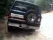 1996 Ford Bronco - Rear view of a dark green 1996 Ford Bronco with a spare tire and chrome bumper.