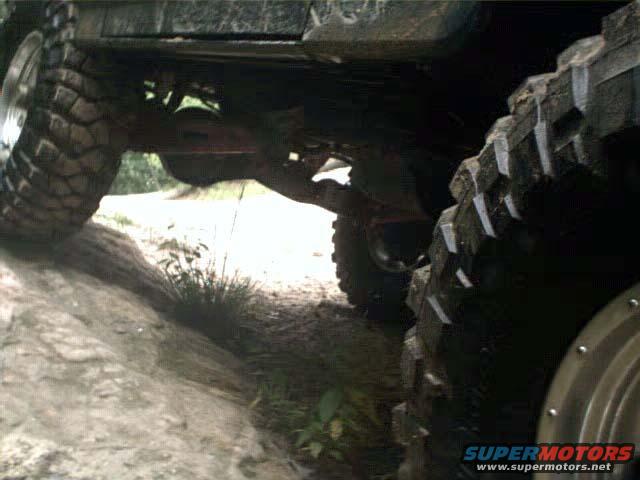 Undercarriage and large tires of an off-road vehicle on rough terrain