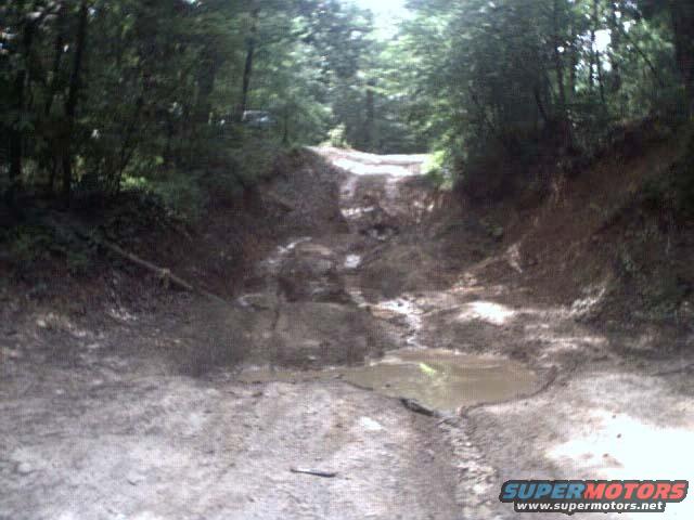 off-road trail with a vehicle in the distance