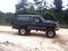 1996 Ford Bronco - Green 1996 Ford Bronco with lifted suspension on a dirt path.