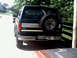 1996 Ford Bronco - This lifted 1996 Ford Bronco features a rear-mounted spare tire and a distinctive two-tone stripe on its side.