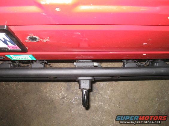 Red 1987 Suzuki Samurai rear bumper with tow hitch and license plate bracket