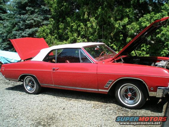 Red 1966 Buick Skylark convertible with white top, hoods open