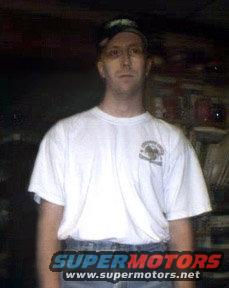 Man wearing a white t-shirt and jeans, with a baseball cap. "SUPERMOTORS www.supermotors.net" logo at bottom