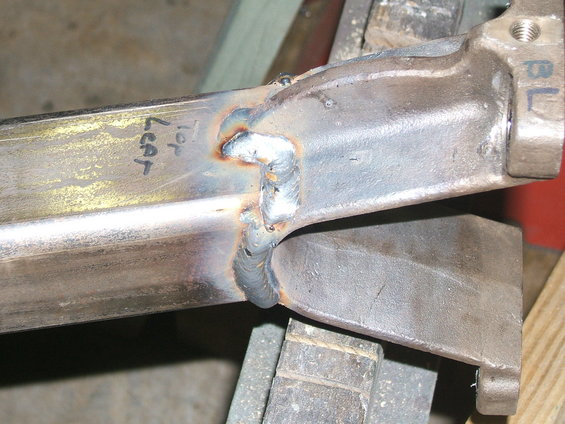 Welded metal component with handwritten text 'Top Leaf' and 'BL'