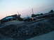 1995 Ford Probe - A black coupe drives past the Two Branch Marina building at dusk.