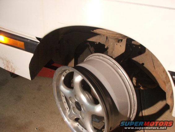 Close-up of a car's wheel and fender well, with the wheel removed