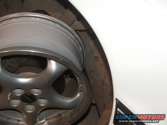 Borbet wheel with five spokes and a black center cap, mounted on a white vehicle's wheel well