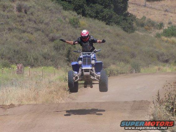 Blue 2001 Yamaha BANSHEE ATV airborne during a jump