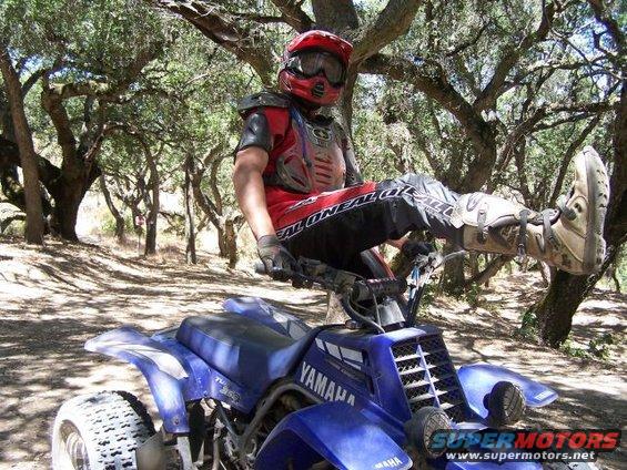 Blue 2001 Yamaha BANSHEE ATV with rider in full gear sitting on it
