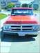 1970 GMC C/K Pickup - Front view of a 1970 GMC C/K Pickup truck with a red exterior and chrome grille.