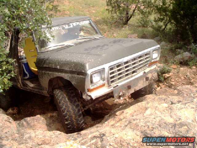 1979 Ford Bronco navigating rocky terrain, front grille visible