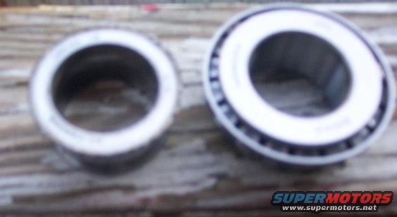 Two wheel bearings on a wooden surface